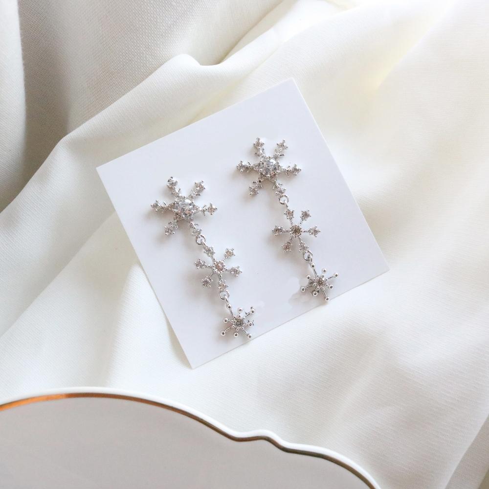 Women Korean earrings hand -made from Korea. Silver snowflakes made from silver 925 material. Non-allergy earrings. Sold by Haru Hana Little Ones Boutique.